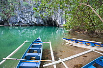 Boats on the river bank by cave entrance, Puerto Princesa Subterranean River National Park, Palawan Philippines, March 2009