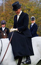 A traditionally dressed lady riding side-saddle at the opening meet of the Quorn Hunt, in Leicestershire, England, UK. October 2009