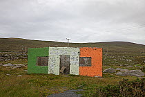 Ruined building painted like the Irish national flag, County Donegal, Republic of Ireland, June 2009