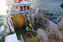 Crew hosing down the deck onboard "Ocean Harvest", North Sea, January 2010.