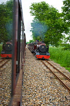 Two steam trains passing each other on the Aylesham Hoveton Bure Valley railway, Norfolk, England, June 2008