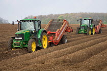 Two tractors planting potatoes, Saxby Wolds, Lincolnshire, April 2009