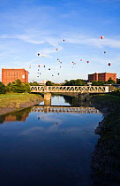 Bristol Balloon Fiesta over bridge and warehouses on the Avon River, Bristol, UK, August 2009.