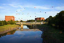 Bristol Balloon Fiesta over bridge and warehouses on the Avon River, Bristol, UK, August 2009.