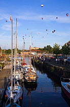 Bristol Balloon Fiesta over yachts moored on the Floating Harbour, Bristol, UK, August 2009.