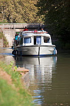 Family cruising on the Canal Du Midi near Carcassonne, Languedoc, France. July 2009. Model and property released.