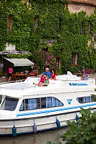 Family cruising on the Canal Du Midi, Le Somail, France. July 2009.