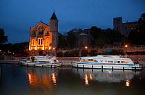 Boats moored at dusk on the Canal Du Midi, Ventenac-en-Minervois, Aude, Languedoc, southern France. July 2009.