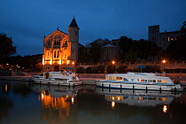 Boats moored at dusk on the Canal Du Midi, Ventenac-en-Minervois, Aude, Languedoc, southern France. July 2009.