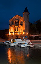 Boat moored at dusk on the Canal Du Midi, Ventenac-en-Minervois, Aude, Languedoc, southern France. July 2009.
