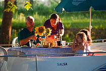 Family having dinner on the Canal Du Midi near Port de Bram, southern France. July 2009. Model and property released.