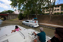 Family cruising on the Canal Du Midi, Carcassonne, southern France. July 2009. Model and property released.