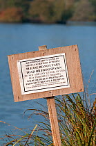 Sign warning against taking frog / toad spawn from water, or adding any spawn to the water, Richmond Park, London, England