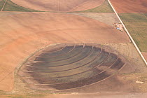 Aerial view of temporary lake (playa) in irrigation circle of crop field, high plains of Texas, USA