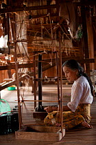 Woman working in a traditional silk factory, Inle Lake, Shan State, Myanmar,  Burma August 2009