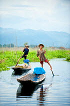 Traditional fishermen with their boats on a narrow river,  Inle Lake, Shan State, Myanmar, Burma. August 2009