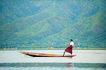 Traditional fisherman, rowing with his feet, Inle Lake, Shan State, Myanmar, Burma. August 2009