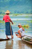 Two Traditional fishermen. These fishermen row with their feet,   Inle Lake, Shan State, Myanmar, Burma. August 2009