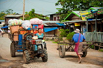 Vehicles and people in the streets of Nyaungshwe, Shan State, Myanmar, Burma. August 2009