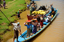People waiting for the boat in the Ayeyarwady river, from Mandalay to Bagan, Myanmar, Burma. September 2009