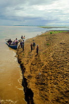 People disembarking a boat in the Ayeyarwady river, from Mandalay to Bagan, Myanmar, Burma. September 2009