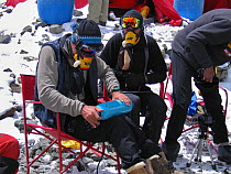 Climbers trying out their oxygen equipment at Advanced Base Camp (6,400m) on Mount Everest, Tibet, May 2006