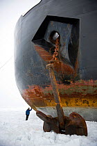 Woman standing by bow and anchor of Russian nuclear icebreaker, "NS 50 Let Pobedy" 50 years of Victory, North Pole, July 2008