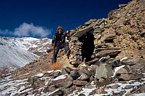 Doug Allan standing outside cave where he lived when filming Snow leopards for BBC series Planet Earth, Mountain valley near Rombuk village, Hemis National Park, Ladakh, India, January 2004. Freeze Fr...