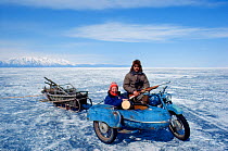 Cameraman, Doug Allan, with seal hunter in motorbike with sidecar, on Lake Baikal, Siberia, Russia, April 1989. Freeze Frame book plate, front cover.