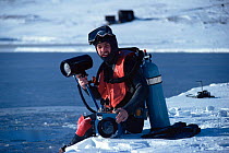 Camerman Doug Allan preparing to film under sea ice, Antarctica, August 1980. Freeze Frame book plate page 38.