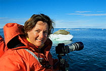 Photographer Sue Flood with Walrus on ice floe in distance, Igloolik, Nunavut, Canadian high Arctic, June 2004