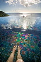 Infinity edge swimming pool with tourist's legs, Jade Mountain hotel, St Lucia, May 2007