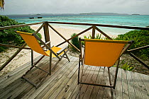 Two empty deckchairs on platform looking out to sea, Vavau islands, Kingdom of Tonga, South Pacific, September 2007
