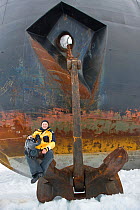 Cameraman Doug Allan, sitting on anchor of Russian nuclear icebreaker, NS 50 Lyet Pobyedi (50 years of Victory) en route to the North Pole, July 2008