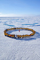 Tourists standing in a circle around the North Pole, July 2008