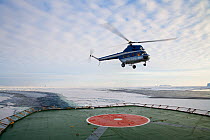 Helicopter above landing pad on boat, along Phantom Coast, Antarctica, November 2008