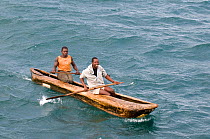 Fishermen in traditional dugout canoe on Lake Malawi, Malawi. March 2009