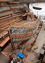 Wooden fishing boat under construction at the Underfall Yard, Bristol, England, UK, 2009.