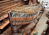 Wooden fishing boat under construction at the Underfall Yard, Bristol, England, UK, 2009.