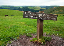 Sign requesting motorists not to travel across fields, Exmoor National Park, England, UK, 2009.