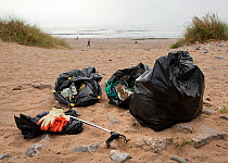 Sacks of litter, mostly plastics, collected by volunteers during an organised Beach Clean Up on Newton Beach, South Wales, UK, Tidy Wales Week, Sept, 2009.