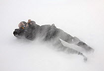 Photographer, Ole Jrgen Liodden, lying on ground photographing in blizzard, Agardhbukta, Spitsbergen, Svalbard, Norway, March 2009 WWE BOOK, WWE OUTDOOR EXHIBITION, WWE INDOOR EXHIBITION.