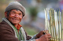 Head portrait of man weaving baskets, Tamang heritage trail, Tatopani, Langtang region, Nepal. November 2009