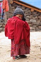 Young boy with shawl and hat, of the Tamang ethnic group, Tamang heritage trail, Thuman, Langtang region, Nepal., November 2009