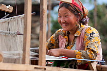 Girl working weaving. Tamang ethnic group, Tamang heritage trail, Thuman, Langtang region, Nepal., November 2009