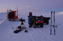 BBC Film crew member with film van, skis, snow buggy and camera equipment, Antarctica on location filming for Planet Earth series. 2005