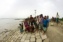 Building a sea wall to combat climate change and protect fishing village from floods, Sundarbans, Bangladesh, October 2008