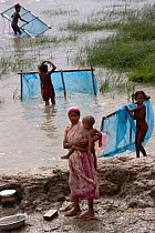 Children fishing for shrimp fry in coastal waters, Sundarbans, Bangladesh, October 2008
