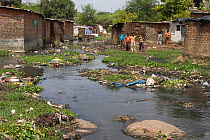 Domestic pollution around stream in slum, Bhopal, Madhya Pradesh, India, November 2008