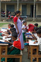 School teacher with class of Primary school children, nr Tala, Ganges delta, Bangladesh, July 2008